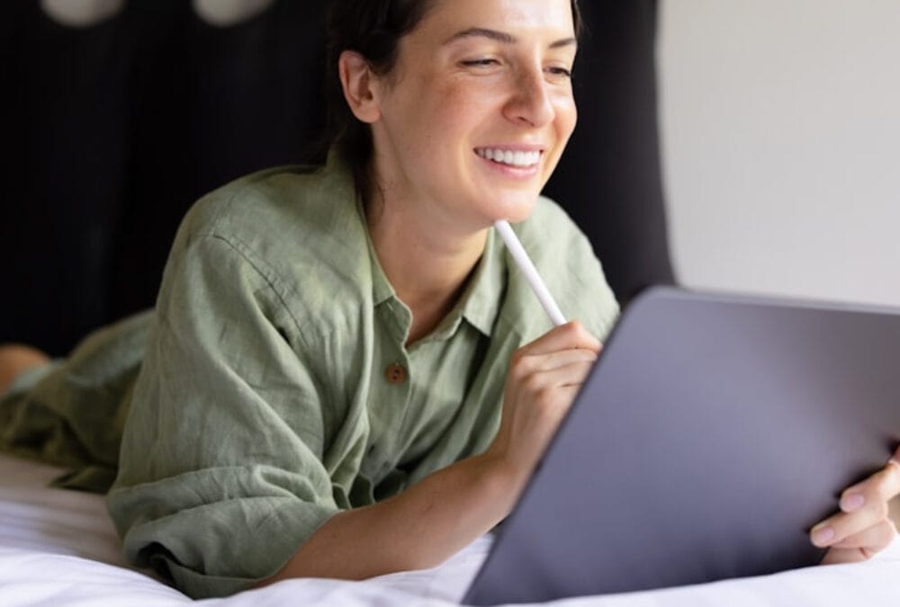 Woman closing laptop with satisfied expression after learning how to stop overthinking