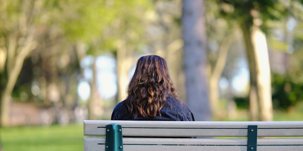 female meditating meditating in the park.